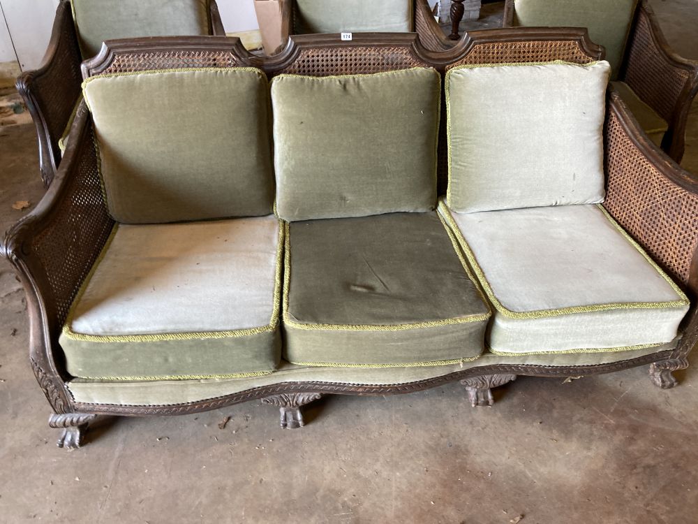 A 1920s carved beech four piece bergere suite